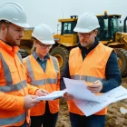Construction team reviewing groundworks plans at a UK site