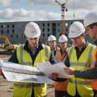 Civil engineering team reviews plans and survey points before excavation