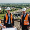 Engineering team discusses Didcot development overlooking railway and new housing
