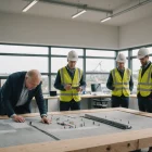 Bridge engineers discuss concrete repairs around a detailed scale model
