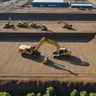 Engineers review site plans as groundworks progress across organised construction zones