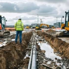 Engineers assess stalled activities across a partially cleared construction site