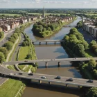 Engineers inspect sustainable bridge works amid restored riverbank and native planting