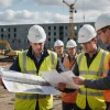 Civil engineering team reviews plans and survey points before excavation