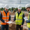 Civil engineers assess soil samples and plans before excavation